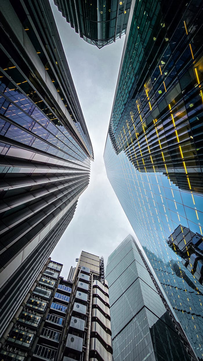 gallery-6 Upward view of modern skyscrapers in London, England showcasing urban architecture.