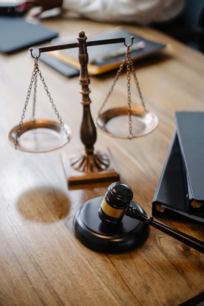 hero-img-02 High angle lawyers desk with decorative judgement scales and gavel in modern law firm